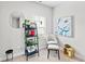 This bedroom is decorated with plants, artwork, and a chair and stool at 230 Fender Walk, Marietta, GA 30060