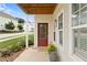 Close-up of front porch with red door and potted flowers for a cozy welcome at 230 Fender Walk, Marietta, GA 30060