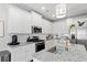 Modern kitchen featuring granite counters, stainless steel appliances, subway tile backsplash, and island sink at 230 Fender Walk, Marietta, GA 30060