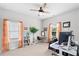 A home office features a large desk, bookcase, and light filled windows at 230 Fender Walk, Marietta, GA 30060