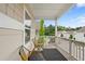 A covered porch features an outdoor rug and two chairs with a street view at 230 Fender Walk, Marietta, GA 30060