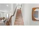 Carpeted staircase with wood railing leading to the upper level of the home at 230 Fender Walk, Marietta, GA 30060