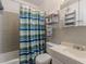 Bathroom featuring a tiled shower-tub, toilet, and sink with neutral tiled walls at 1705 Monroe Ne Dr # D05, Atlanta, GA 30324