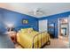 Bedroom featuring blue walls, bed with yellow comforter, carpet, and closet at 1705 Monroe Ne Dr # D05, Atlanta, GA 30324