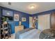 Bedroom featuring blue walls, closet, and a cozy bed with book shelves and TV at 1705 Monroe Ne Dr # D05, Atlanta, GA 30324