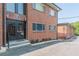 Brick apartment building showing main entrance with glass doors and street-side parking at 1705 Monroe Ne Dr # D05, Atlanta, GA 30324