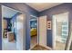 Hallway leading to the bedroom and bathroom with a tiled floor, blue walls, and white trim at 1705 Monroe Ne Dr # D05, Atlanta, GA 30324