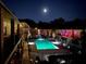 Illuminated outdoor pool at night surrounded by condo buildings with well-lit balconies, creating a tranquil setting at 1705 Monroe Ne Dr # D05, Atlanta, GA 30324