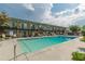 Inviting pool surrounded by lounge chairs with green condo units in the background, perfect for relaxation at 1705 Monroe Ne Dr # D05, Atlanta, GA 30324