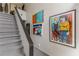 Carpeted staircase with black metal handrail and artwork, adding a touch of sophistication at 1705 Monroe Ne Dr # D05, Atlanta, GA 30324