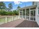 Inviting screened-in porch with wood flooring and decorative railings, perfect for outdoor relaxation at 2802 Arabian Ne Trl, Marietta, GA 30062