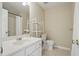 Bright bathroom features a white vanity, tile floors, a large mirror, and access to an enclosed shower and toilet at 2802 Arabian Ne Trl, Marietta, GA 30062