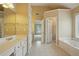 Bathroom boasts dual vanities, tile flooring, a soaking tub, and natural light from windows at 2802 Arabian Ne Trl, Marietta, GA 30062