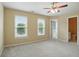 A neutral-toned bedroom featuring carpet floors, large windows, and an ensuite bathroom at 2802 Arabian Ne Trl, Marietta, GA 30062