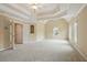 Spacious bedroom features a tray ceiling, ceiling fan, and is illuminated by natural light from many windows at 2802 Arabian Ne Trl, Marietta, GA 30062
