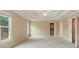 A spacious bedroom offers carpet flooring, neutral walls, and two windows with views of the surrounding landscape at 2802 Arabian Ne Trl, Marietta, GA 30062