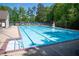 Community pool with marked lanes, lifeguard stand, lounge chairs, and a fenced perimeter at 2802 Arabian Ne Trl, Marietta, GA 30062