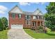 Stately two-story brick home with manicured lawn, two-car garage, and well-maintained landscaping at 2802 Arabian Ne Trl, Marietta, GA 30062