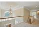 A bright hallway features a decorative chandelier and a large window with great natural light at 2802 Arabian Ne Trl, Marietta, GA 30062