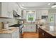 Well-equipped kitchen featuring stainless steel appliances, granite countertops, and views of the backyard at 2802 Arabian Ne Trl, Marietta, GA 30062