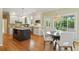 Modern kitchen with a center island, granite countertops, white cabinetry, and dining area at 2802 Arabian Ne Trl, Marietta, GA 30062
