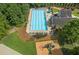 Aerial view of a fenced community pool with lounge chairs, umbrellas, and a nearby playground at 2802 Arabian Ne Trl, Marietta, GA 30062
