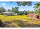 View of the spacious backyard with a barn and a house in the background at 2905 Jim Owens Nw Rd, Kennesaw, GA 30152
