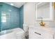 Modern bathroom with a tile shower, glass enclosure and stylish vanity with gold fixtures at 2905 Jim Owens Nw Rd, Kennesaw, GA 30152