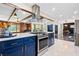 Modern, open kitchen with stainless appliances, large island, and view to living area at 2905 Jim Owens Nw Rd, Kennesaw, GA 30152