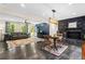 Open-concept living area with fireplace, hardwood floors and custom wall accents at 2905 Jim Owens Nw Rd, Kennesaw, GA 30152