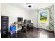 Bright home office featuring hardwood floors, a large window and plenty of workspace at 2905 Jim Owens Nw Rd, Kennesaw, GA 30152