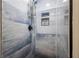 Modern shower featuring blue accent tiles, built-in shelves, and a rainfall shower head at 2905 Jim Owens Nw Rd, Kennesaw, GA 30152