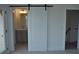Modern bathroom featuring a sliding barn door and a vanity with gray cabinets at 297 White St # 1, Marietta, GA 30060