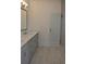 Bathroom boasts double sink vanity, granite countertop, and tile floors at 297 White St # 1, Marietta, GA 30060