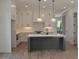 Modern kitchen with gray island, white cabinets, quartz countertops, and stainless steel appliances at 297 White St # 1, Marietta, GA 30060