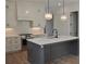 Bright, modern kitchen featuring a gray island, white cabinetry, and stylish pendant lighting at 297 White St # 1, Marietta, GA 30060