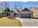 Charming one-story home with a well-maintained lawn and attached two-car garage at 245 Raleigh Way, Villa Rica, GA 30180