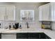 Kitchen sink with white subway tile backsplash, marble countertops, and stainless steel appliances at 245 Raleigh Way, Villa Rica, GA 30180