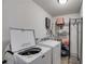 Laundry room with washer, dryer, and wire rack shelving for storage at 245 Raleigh Way, Villa Rica, GA 30180