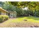 Green backyard includes a patio, shed, fire pit, and access to a sunroom at 2753 Fireside Se Ct, Marietta, GA 30067
