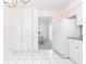 White kitchen featuring ample cabinets, granite counters, and a peek into dining area at 2753 Fireside Se Ct, Marietta, GA 30067