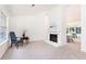 Spacious living room with a white stone fireplace, soft carpet, and natural light from the window at 2753 Fireside Se Ct, Marietta, GA 30067