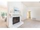 Bright living room with a stone fireplace, soft carpet, and view of the dining area at 2753 Fireside Se Ct, Marietta, GA 30067