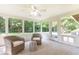 Bright sunroom with neutral carpet, ceiling fan, and multiple windows offering wooded views at 2753 Fireside Se Ct, Marietta, GA 30067