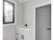 Bathroom vanity with white countertop, new fixtures, and a window with backyard view at 37 Deer Canyon Dr, Auburn, GA 30011