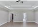 Spacious bedroom with tray ceiling, recessed lighting, and neutral walls at 37 Deer Canyon Dr, Auburn, GA 30011