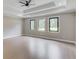 Bright bedroom with tray ceiling and three large windows overlooking the green backyard at 37 Deer Canyon Dr, Auburn, GA 30011