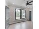 Bedroom with a ceiling fan, two windows overlooking trees, and gray doors at 37 Deer Canyon Dr, Auburn, GA 30011