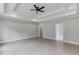 Spacious bedroom with tray ceiling, recessed lighting, and light hardwood floors at 37 Deer Canyon Dr, Auburn, GA 30011