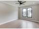 Bedroom with two windows, hardwood floors, a ceiling fan, and white trim at 37 Deer Canyon Dr, Auburn, GA 30011